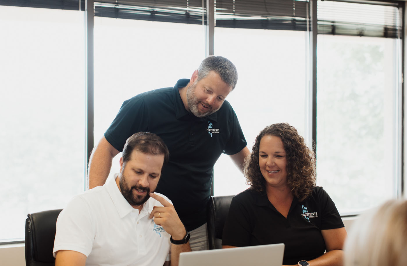 Footprints Bath and Tile team working in their corporate office.