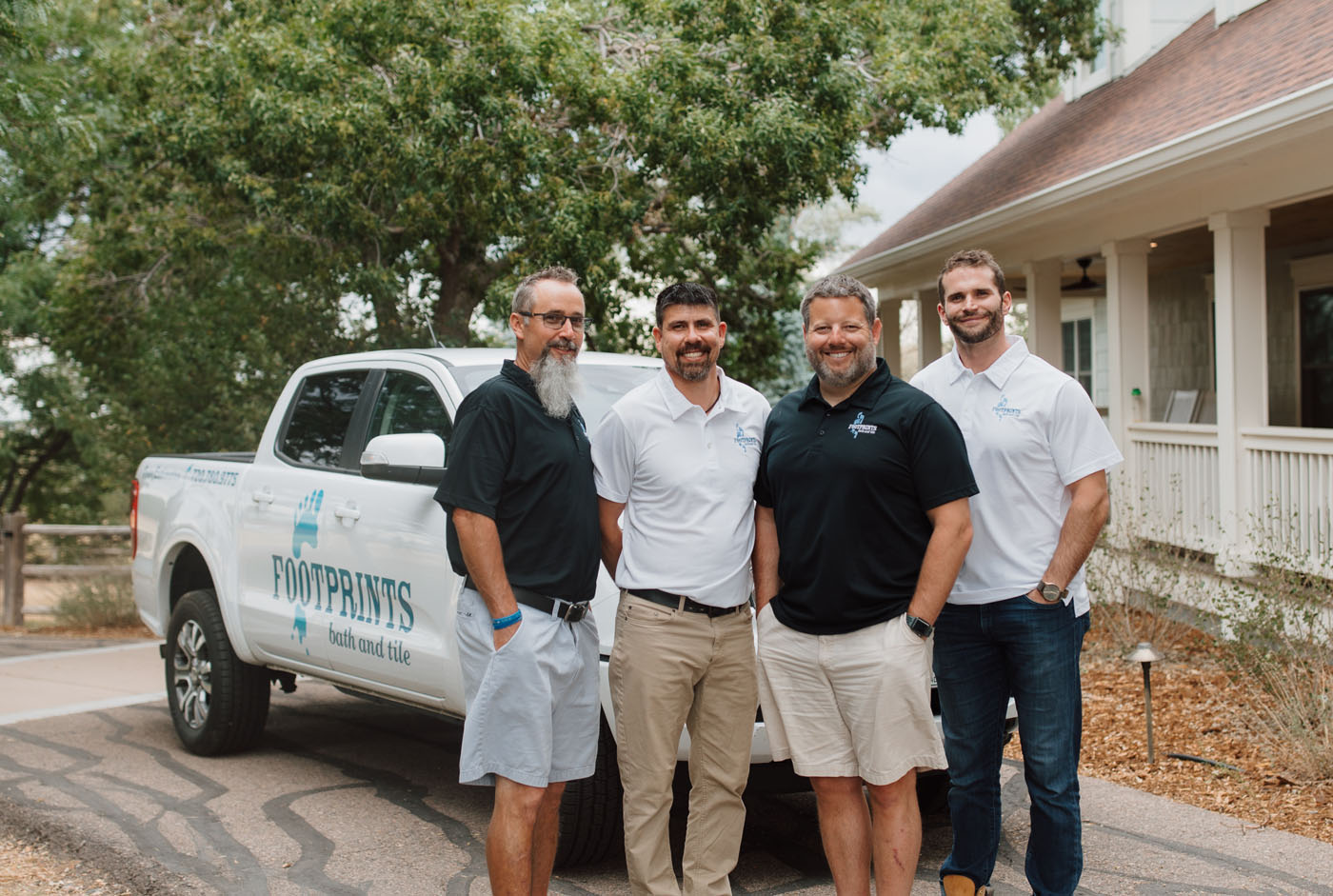 A few Footprints Bath and Tile team members and their service vehicle - our values make us one of the best tile installation and bathroom remodel companies in Columbus, OH.