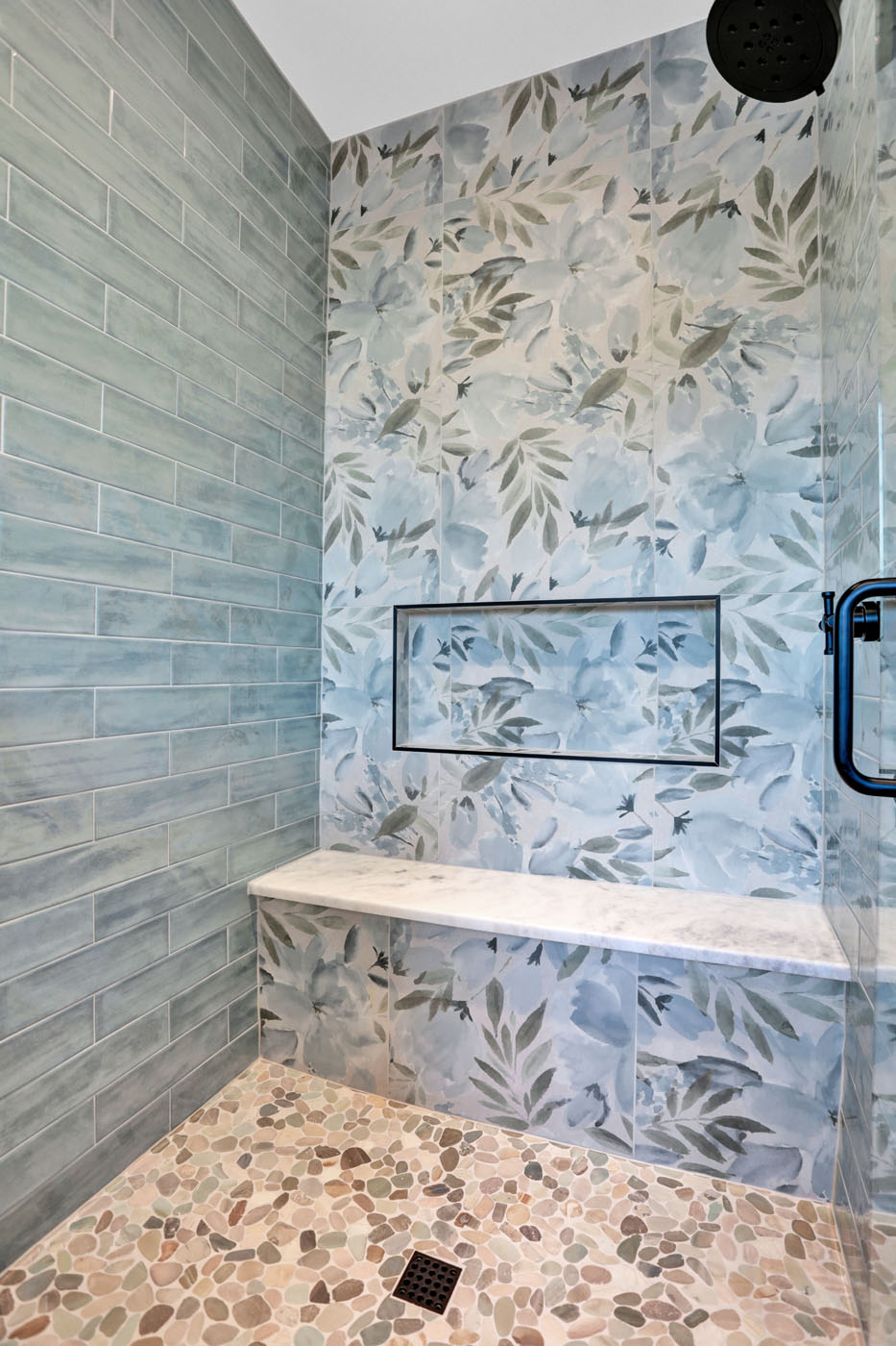 A floral shower tile recently installed by Footprints Bath and Tile Raleigh.