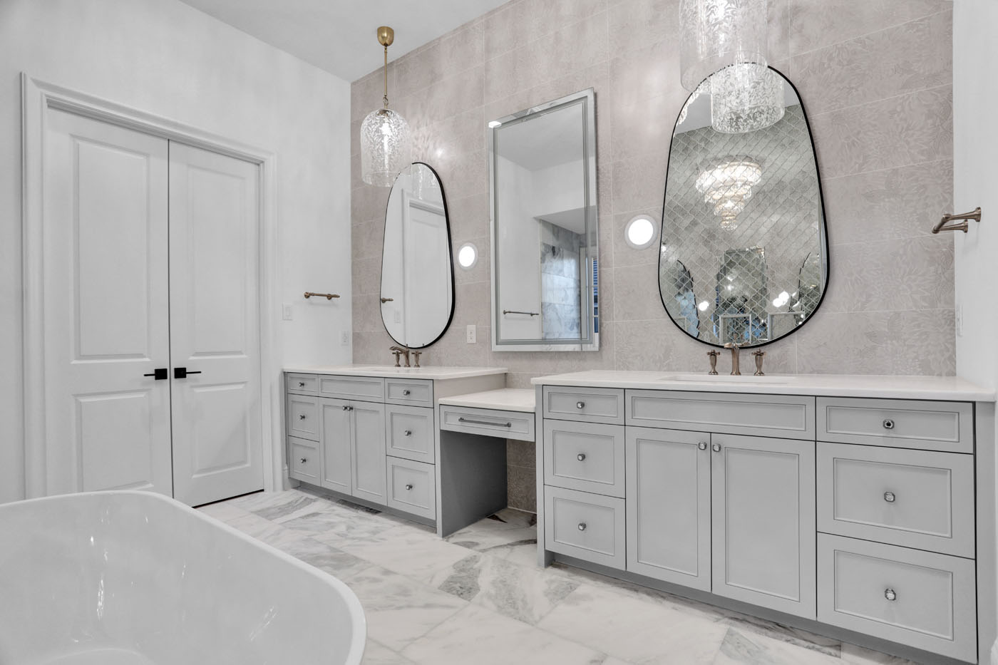 A refinished bathroom by Footprints Bath and Tile Raleigh with a beautiful vanity.