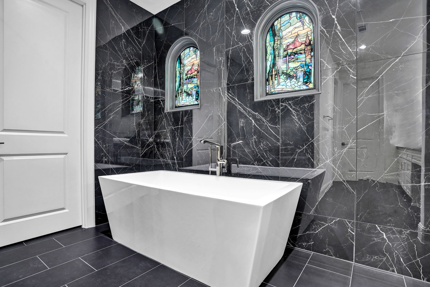 A beautiful redesigned bathroom withe black tile by Footprints Bath and Tile Raleigh.