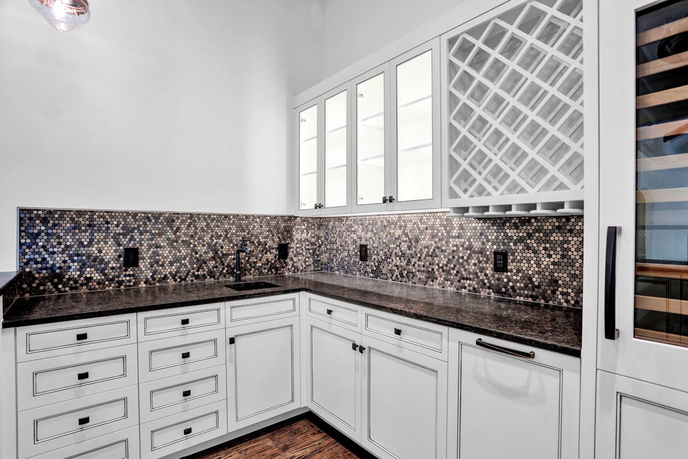 An image of counstertop backsplash in a modern kitchen with Footprints Bath and Tile.