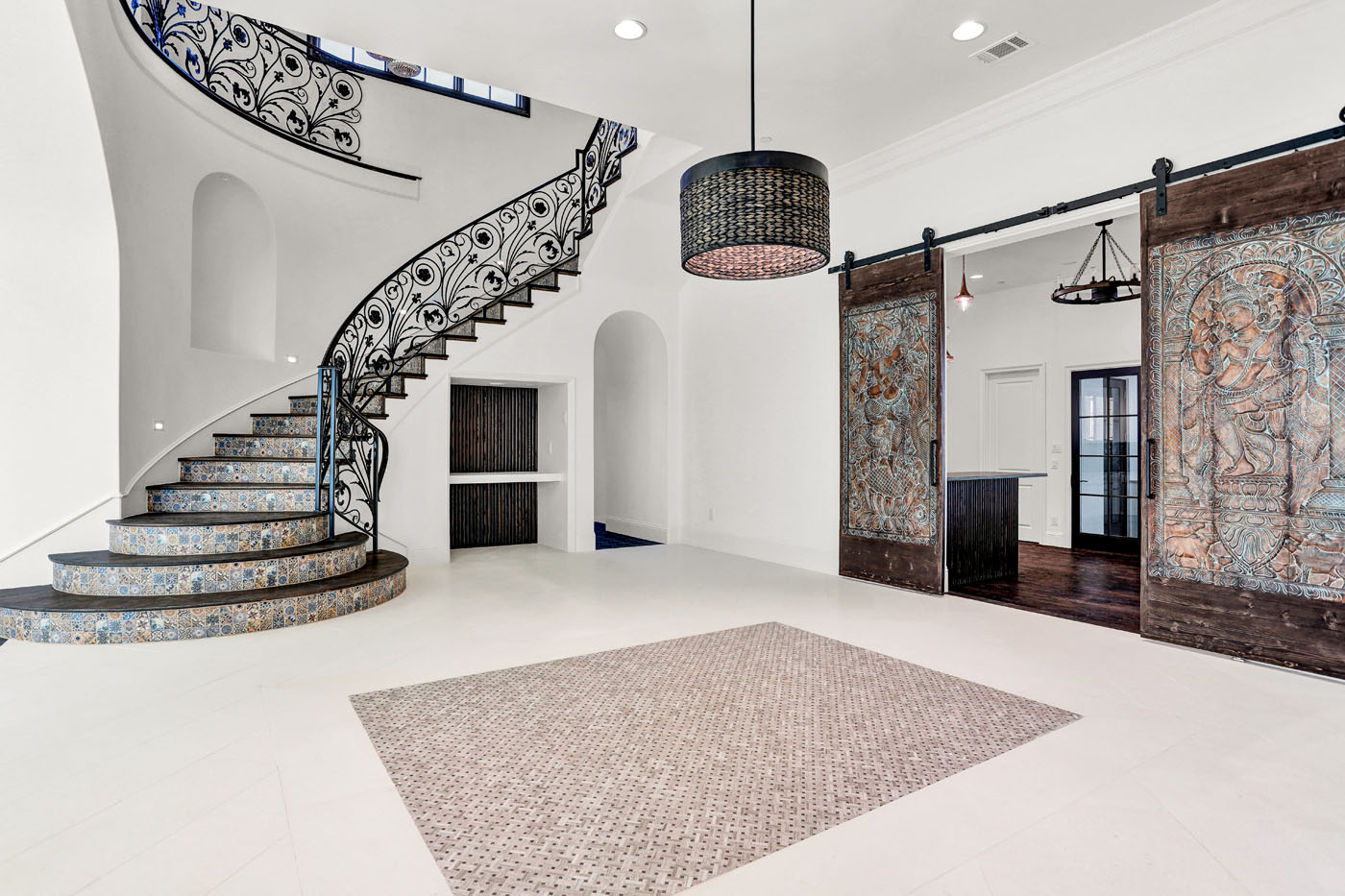 A beautiful updated tiled entryway and staircase by Footprints Bath and Tile Raleigh.