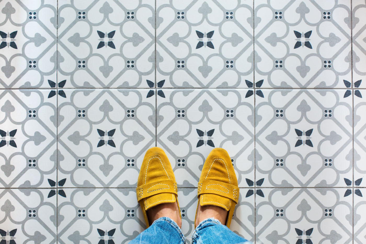 A homeowner walking through their fully remodeled tile bathroom.