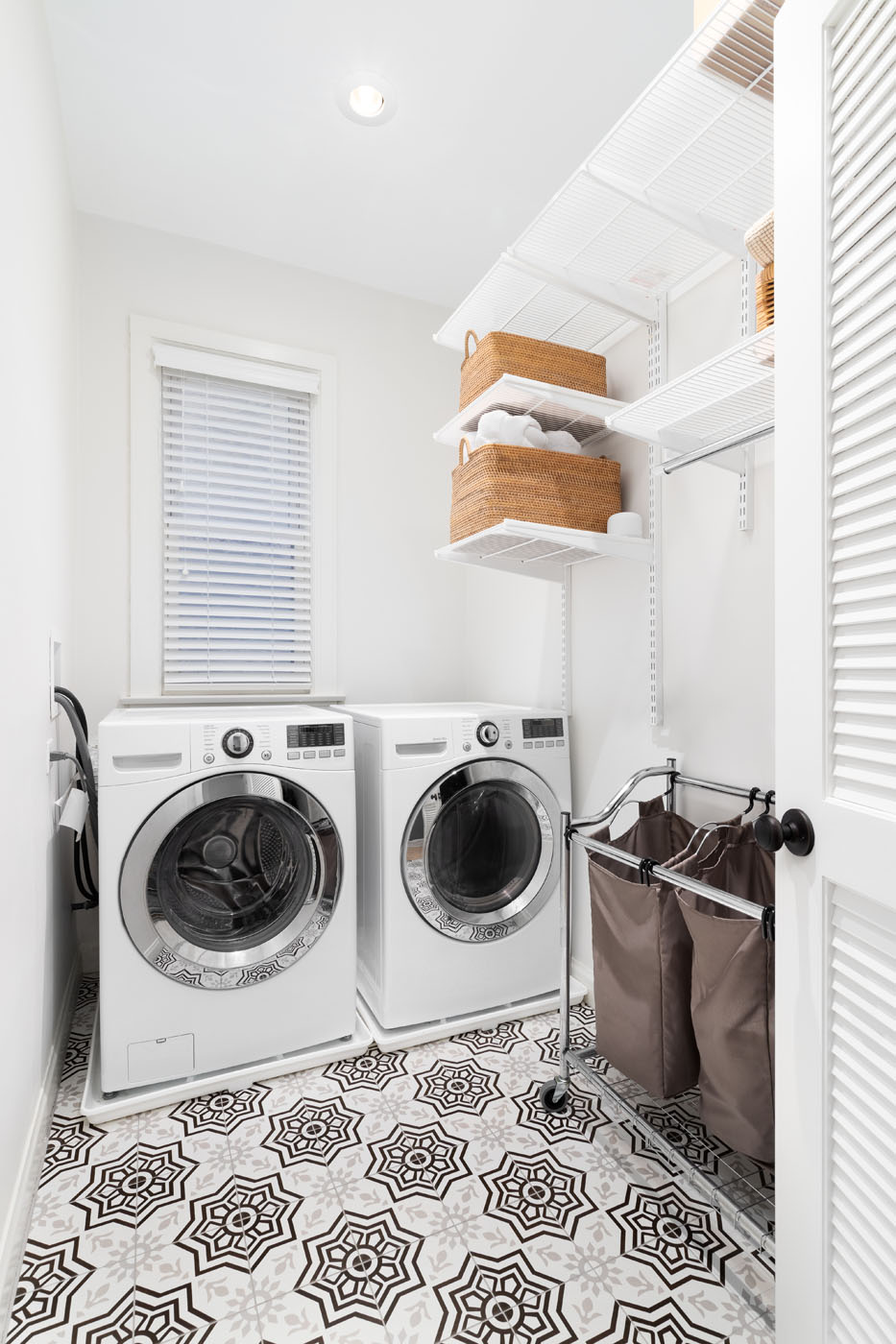 A laundry room with a beautiful geometric pattern tile floor - trust Footprints Bath and Tile for laundry room tile instalaltion in Broomfield / Boulder, CO today.