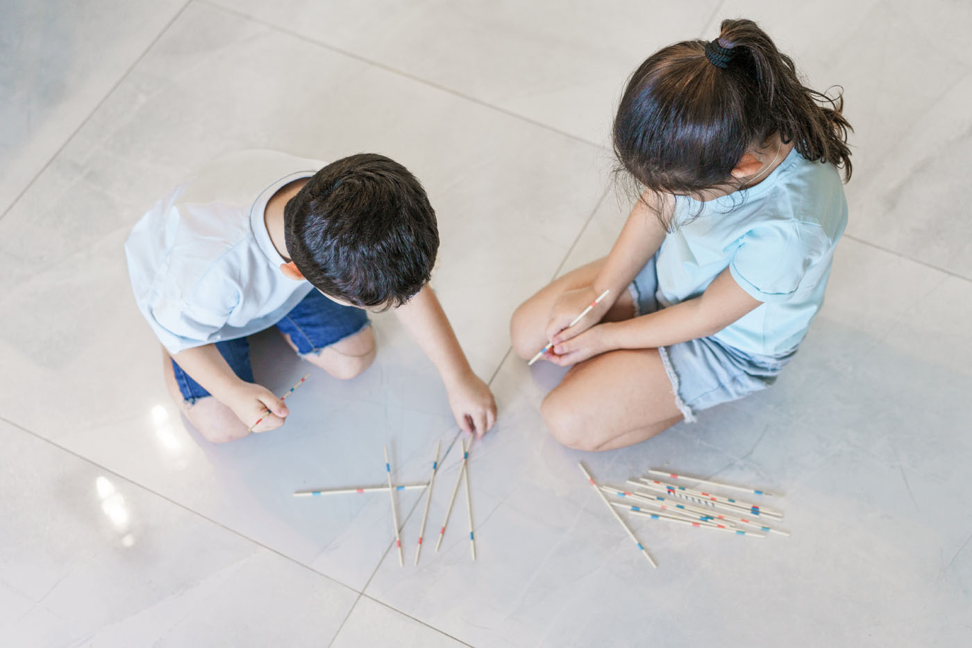 Two kids playing on tile flooring in their Columbus home.