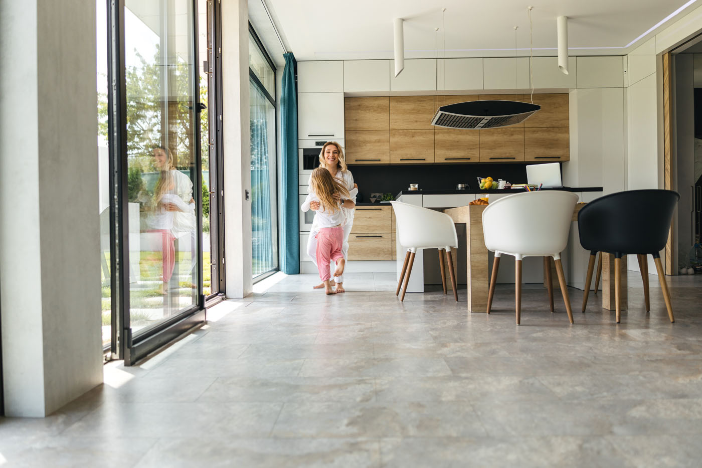 An image of a family and their beautiful kitchen tile installation in Charlotte, NC from Footprints Bath and Tile.