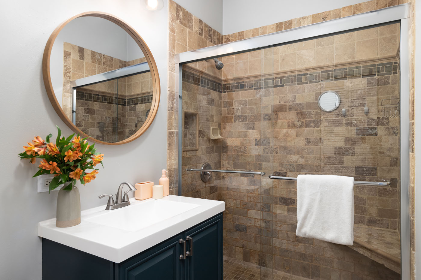 A newly installed Broomfield / Boulder guest bathroom renovation with travertine tile from Footprints Bath and Tile.